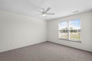 A room with a ceiling fan and a window with blinds.at Arlington Farms, Greenwood, IN, 46143