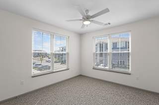 A room with a ceiling fan and two windows.at Arlington Farms, Greenwood, Indiana