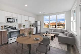 A modern kitchen with a dining table and chairs.