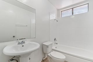 A white bathroom with a sink, toilet and bathtub.