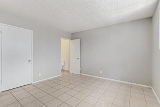 A room with a white door and a white wall.
