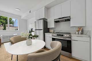 A modern kitchen with a table and chairs.