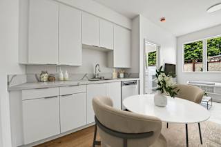 A modern kitchen with a dining table and chairs.