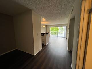 A long hallway with a door on the right.