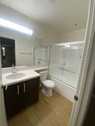 a bathroom with a toilet and a sink and a shower