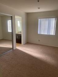 an empty room with a window and a mirror