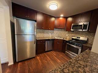 a kitchen with stainless steel appliances and wooden cabinets