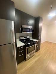 a kitchen with a stove and a refrigerator