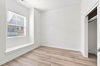 A room with a window and a door.