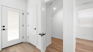 A white door with a black handle is on the left.at Alante Homes at Spring Run, Caldwell Idaho