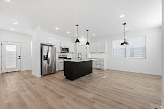 Spacious Kitchen with hanging lights and wooden floor at Alante Homes at Spring Run, Caldwell, ID