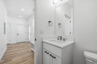 Modern bathroom interior with wooden floor at Alante Homes at Spring Run, Idaho