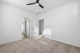 Carpeted floor in a vacant room with ceiling fan at Alante Homes at Spring Run, Caldwell, 83607