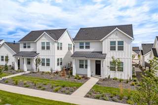 A white house with a black roof and a grey front yard. at Alante Homes at Spring Run, Caldwell, ID