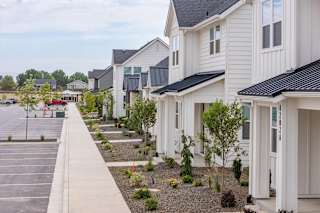 A row of houses with a parking lot in front. at Alante Homes at Spring Run, Caldwell