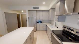 A modern kitchen with a refrigerator, oven, and microwave. at Paperbox Lofts Apartments, Utah