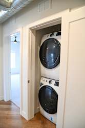 Stacked washer and dryer in hallway closet at The Revival Apartments, Utah