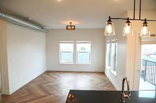 Open layout living and dining area with pendant lighting at The Revival Apartments, Salt Lake City, UT