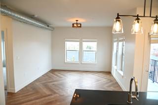 Open living and dining area with pendant lighting at The Revival Apartments, Salt Lake City, 84101