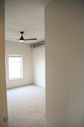 Empty bedroom with carpeting and exposed ductwork at The Revival Apartments, Salt Lake City, 84101