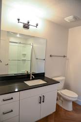 Bathroom with white vanity and glass shower door at The Revival Apartments, Utah, 84101