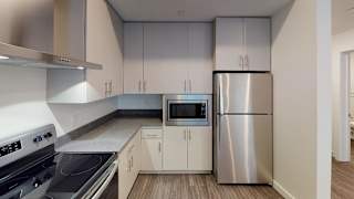 A modern kitchen with a stainless steel refrigerator and microwave. at Paperbox Lofts Apartments, Utah