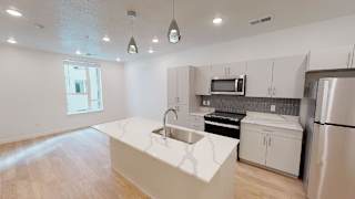 A kitchen with a white counter top and stainless steel appliances. at SevenO2 Main Apartments, Salt Lake City, UT, 84101