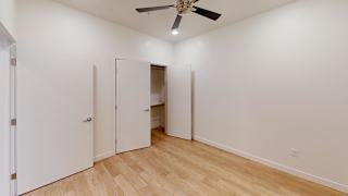 A room with a ceiling fan and three white doors. at SevenO2 Main Apartments, Utah