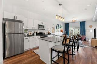 A modern kitchen with a large island and stainless steel appliances.