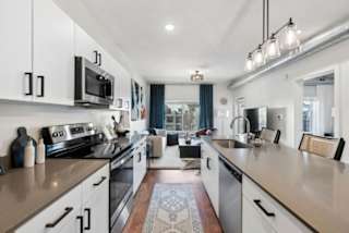 A modern kitchen with white cabinets and a large island.