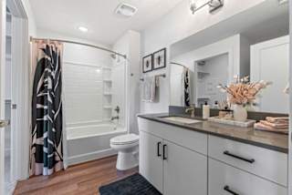 A bathroom with a white toilet, a white bathtub, and a white sink.