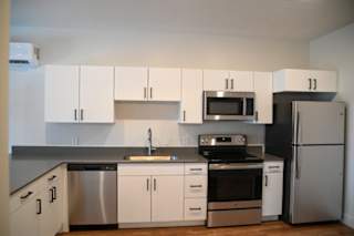 Contemporary kitchen with gray countertops and stainless appliances at The Revival Apartments, Utah