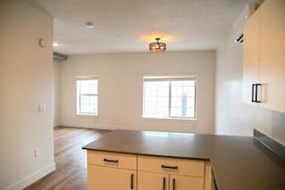 Open kitchen and living room with large windows at The Revival Apartments, Salt Lake City, UT