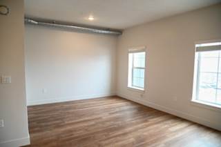 Empty bedroom with laminate flooring and windows at The Revival Apartments, Salt Lake City, 84101