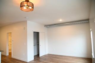 Empty bedroom with closet and exposed ductwork at The Revival Apartments, Utah, 84101