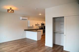 Open floor plan with kitchen island and closet at The Revival Apartments, Salt Lake City, UT 84101