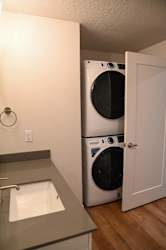 Bathroom with stacked washer dryer and undermount sink at The Revival Apartments, Salt Lake City, 84101