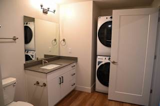 Bathroom with stacked washer dryer in closet at The Revival Apartments, Salt Lake City, Utah