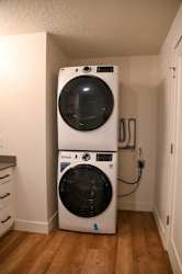 Stacked front load washer and dryer in alcove at The Revival Apartments, Salt Lake City