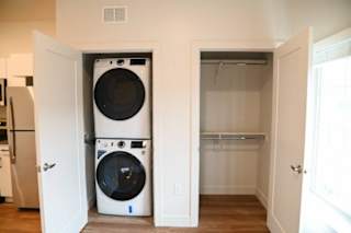 Stacked washer and dryer with closet storage at The Revival Apartments, Salt Lake City, 84101