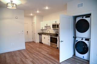 Studio apartment with kitchen and stacked washer dryer at The Revival Apartments, Salt Lake City, Utah