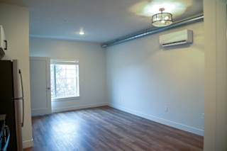 Spacious living area with wood style flooring at The Revival Apartments, Utah, 84101