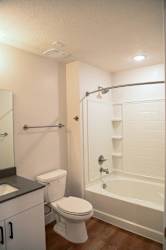 Bathroom with tub shower combo and modern fixtures at The Revival Apartments, Salt Lake City, UT