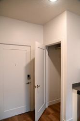 Entry closet with hanging rod and door at The Revival Apartments, Salt Lake City, Utah