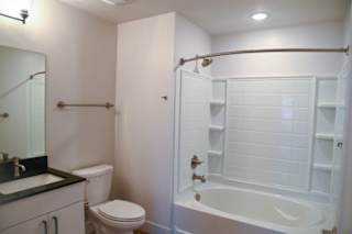 A white bathroom with a toilet, sink, and bathtub.