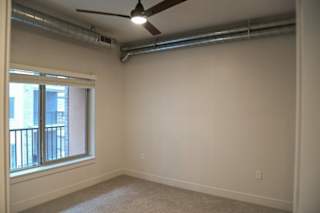 Empty bedroom with ceiling fan at The Revival Apartments, Salt Lake City, UT