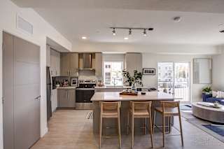 A modern kitchen with a dining table and chairs. at Paperbox Lofts Apartments, Utah, 84101