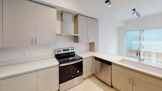 A kitchen with a stove, sink, and cabinets. at Paperbox Lofts Apartments, Salt Lake City
