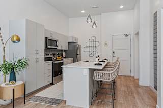 A modern kitchen with a dining table and chairs.