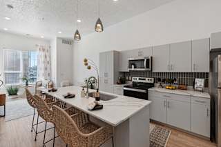 A modern kitchen with a dining table and chairs.